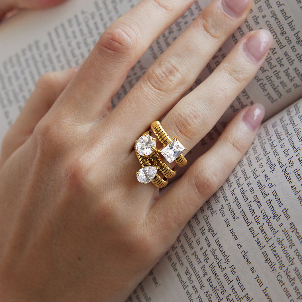 Square round and pear zirconia rings stacked on one finger