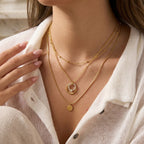 Circle pendant necklace layered with separate plain necklaces