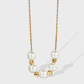 gold plated necklace with seven round white shell pearls
