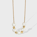 gold plated necklace with seven round white shell pearls