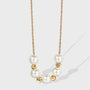 gold plated necklace with seven round white shell pearls