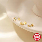 three petite celestial studs arranged on a cream display