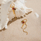 gold plated fish and bead tassel earrings styled by a shell