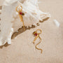 gold plated fish and bead tassel earrings styled by a shell