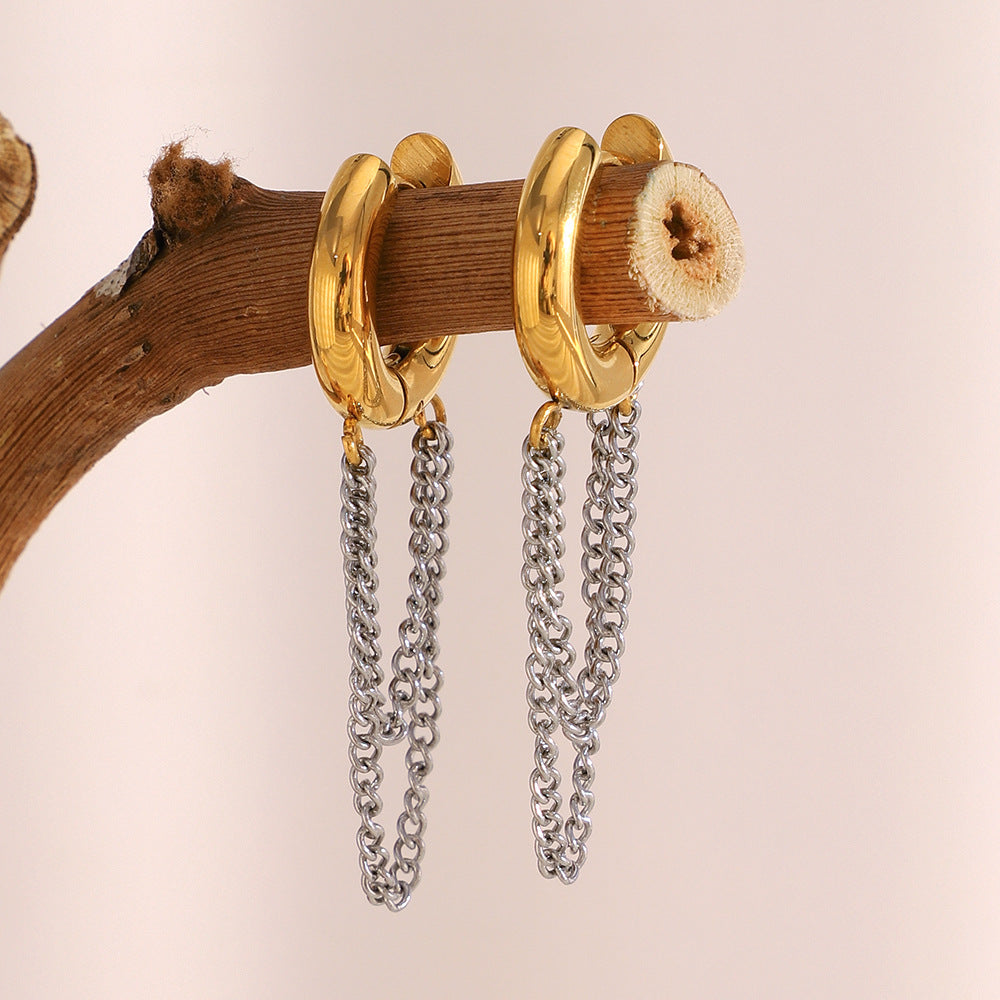 two-tone chain drop hoop earrings displayed on wood
