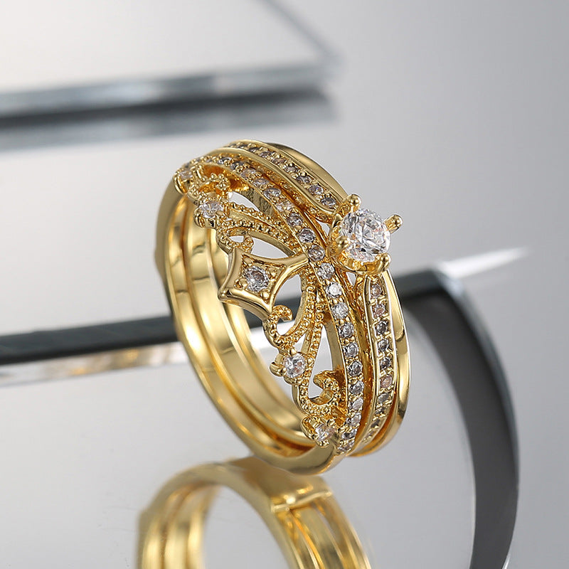 gold plated crown-inspired statement ring standing on a mirror