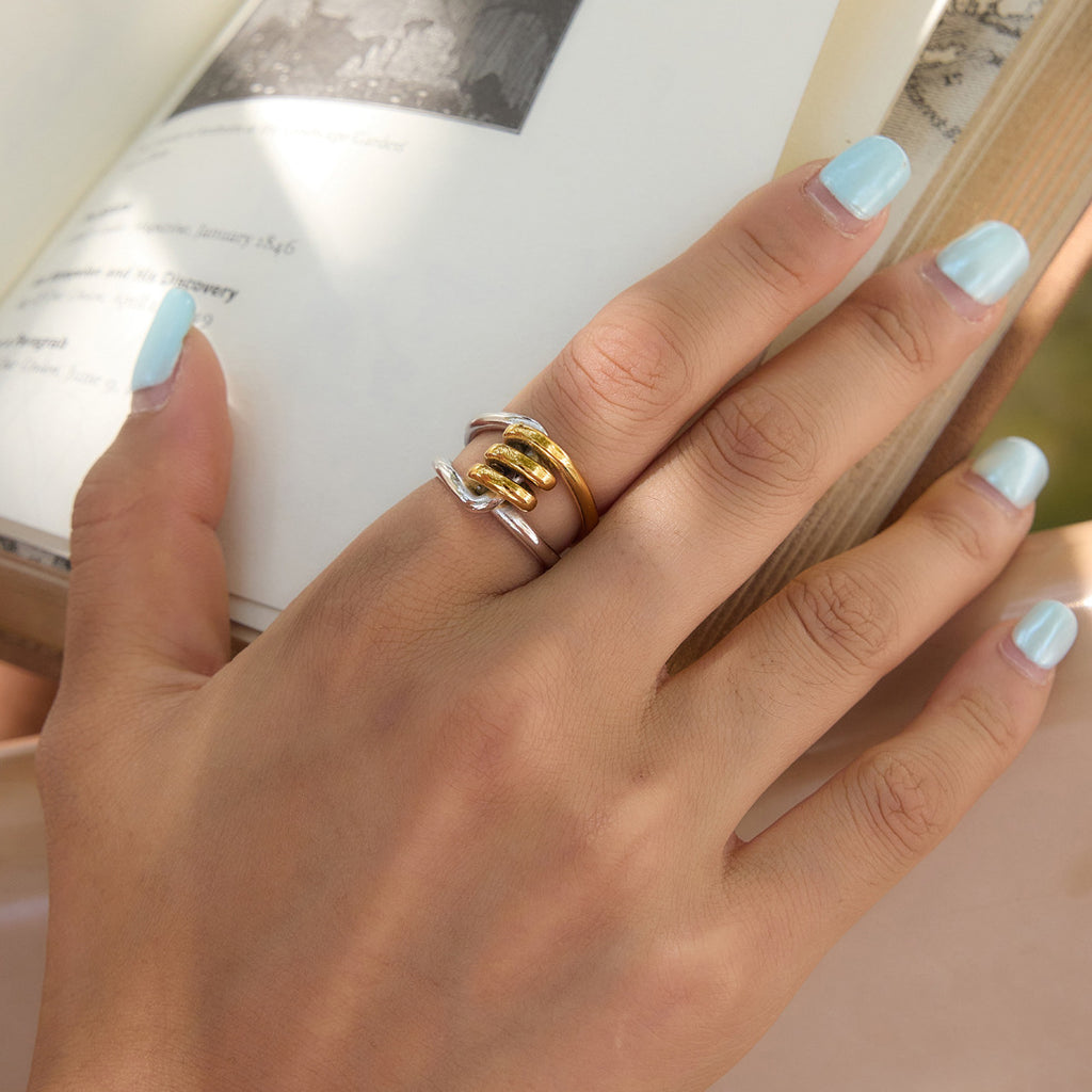 Mixed-tone sculptural ring shown in a hand close-up
