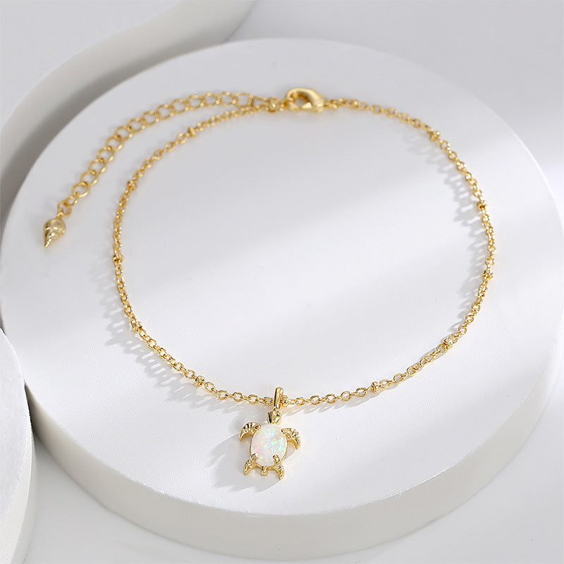 sea turtle iridescent charm anklet styled on a white display