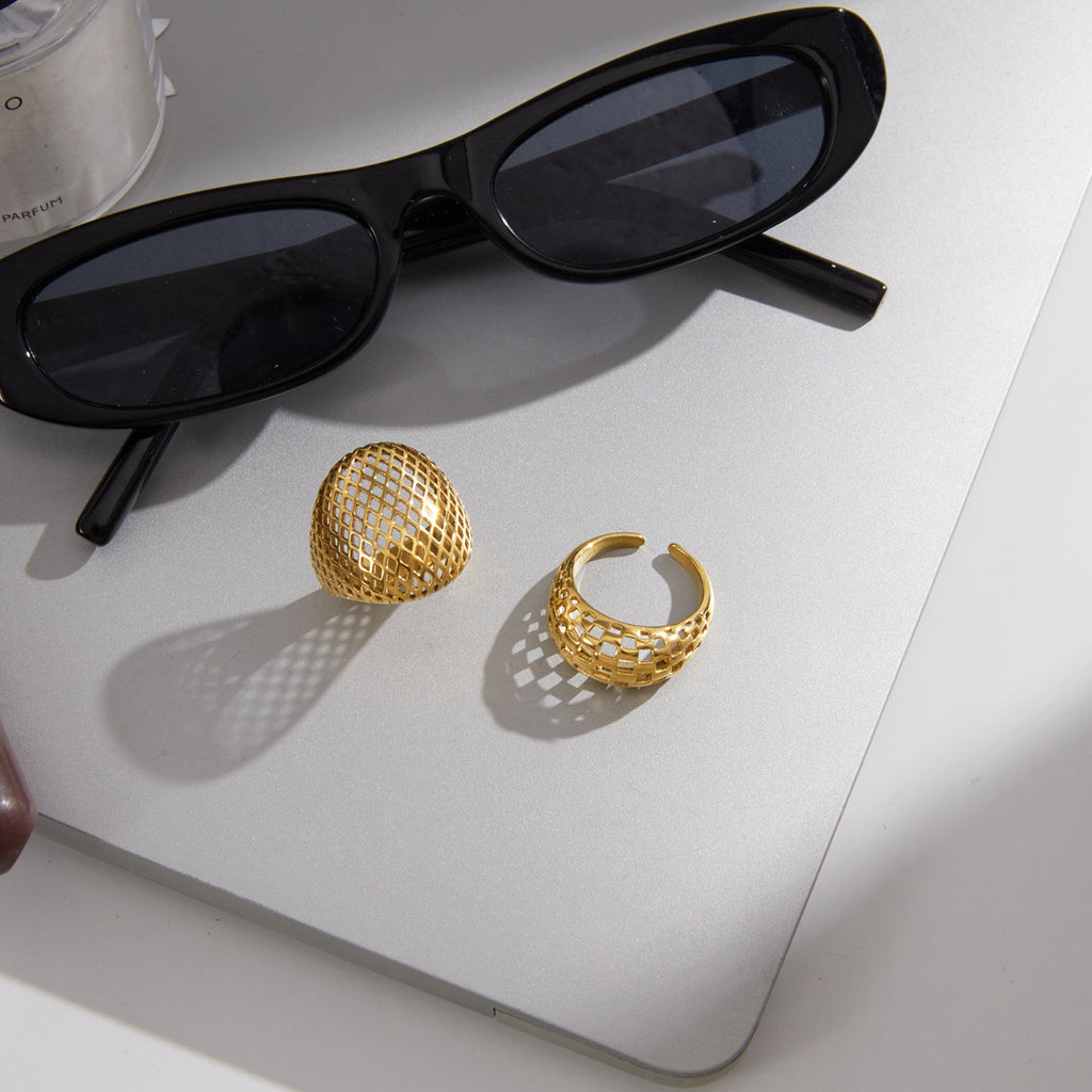 Openwork rings displayed beside sunglasses