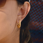 side view of sculptural clear-rhinestone huggie earring