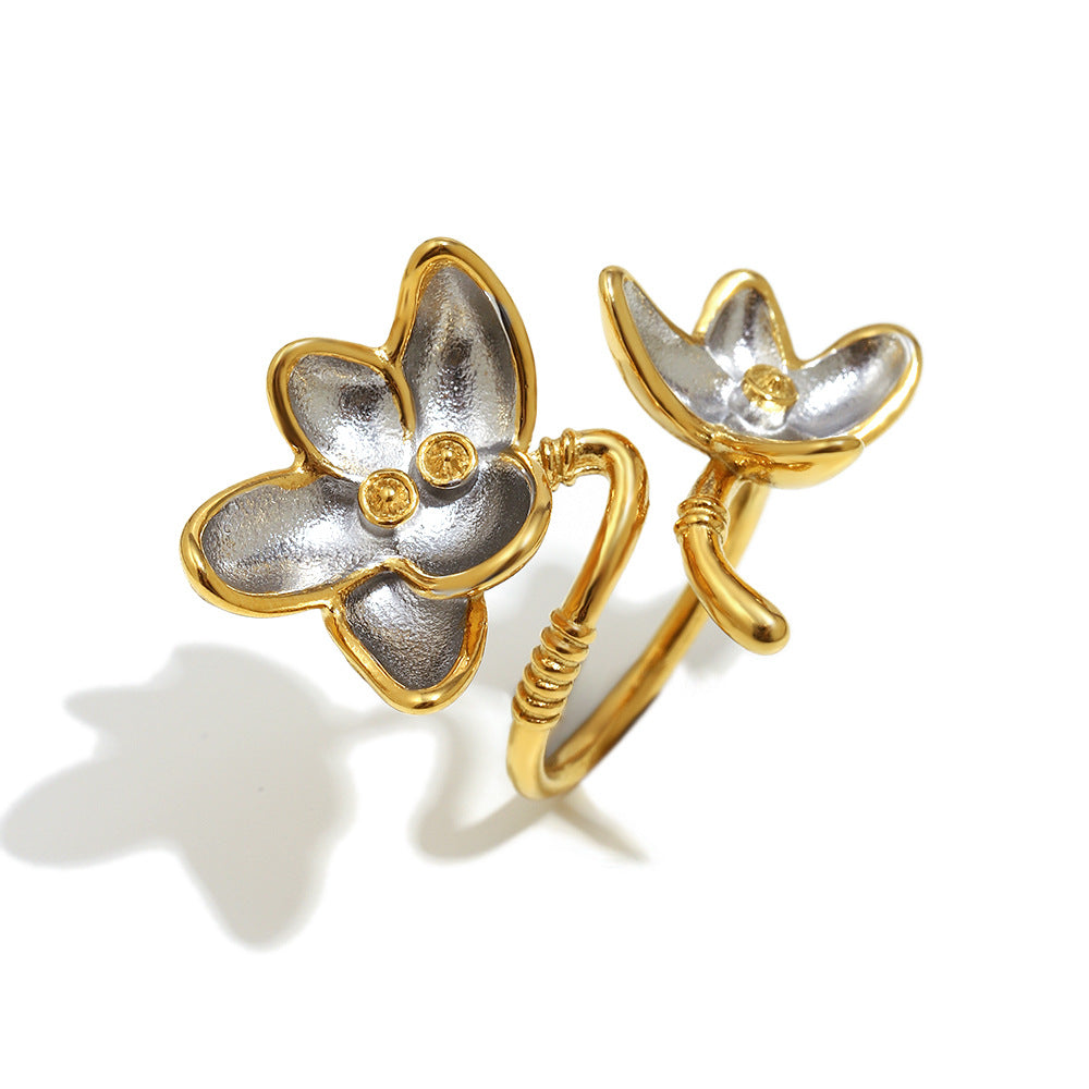 isolated two-tone stainless steel floral open ring on white