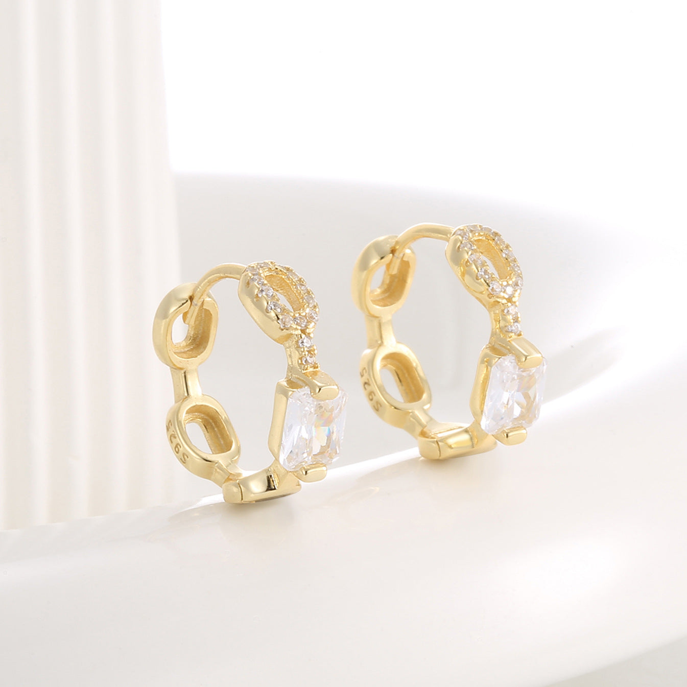 angled pair of open-link hoops with square and small zirconia