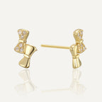 gold plated asymmetric clear stone bow stud earrings front and side view
