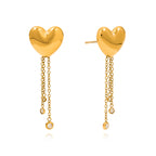 isolated stainless steel heart earrings with clear stone chain accents