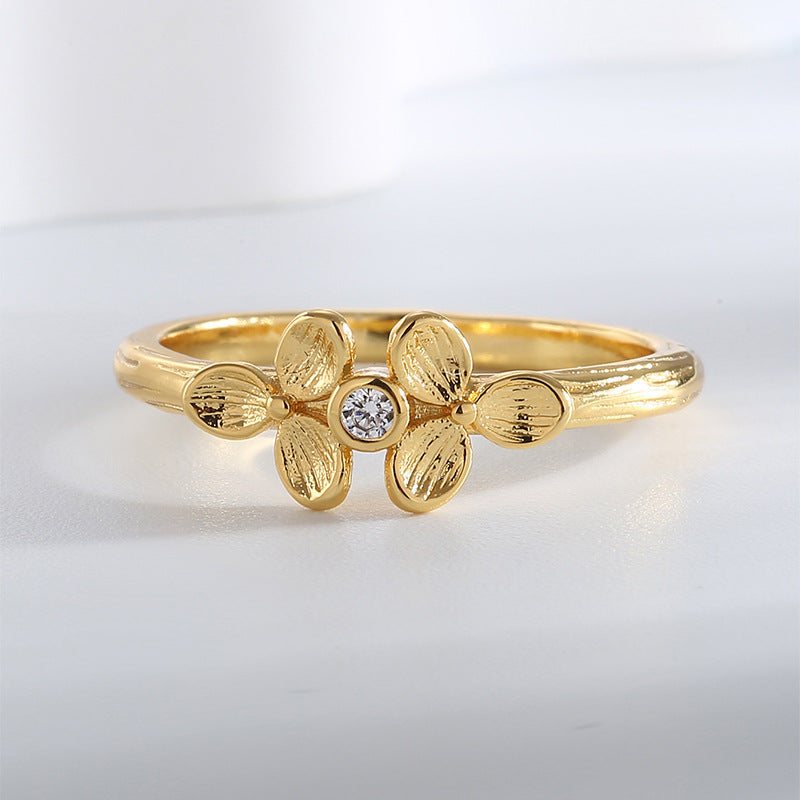 top view of clover ring with small round clear center stone