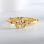 top view of clover ring with small round clear center stone