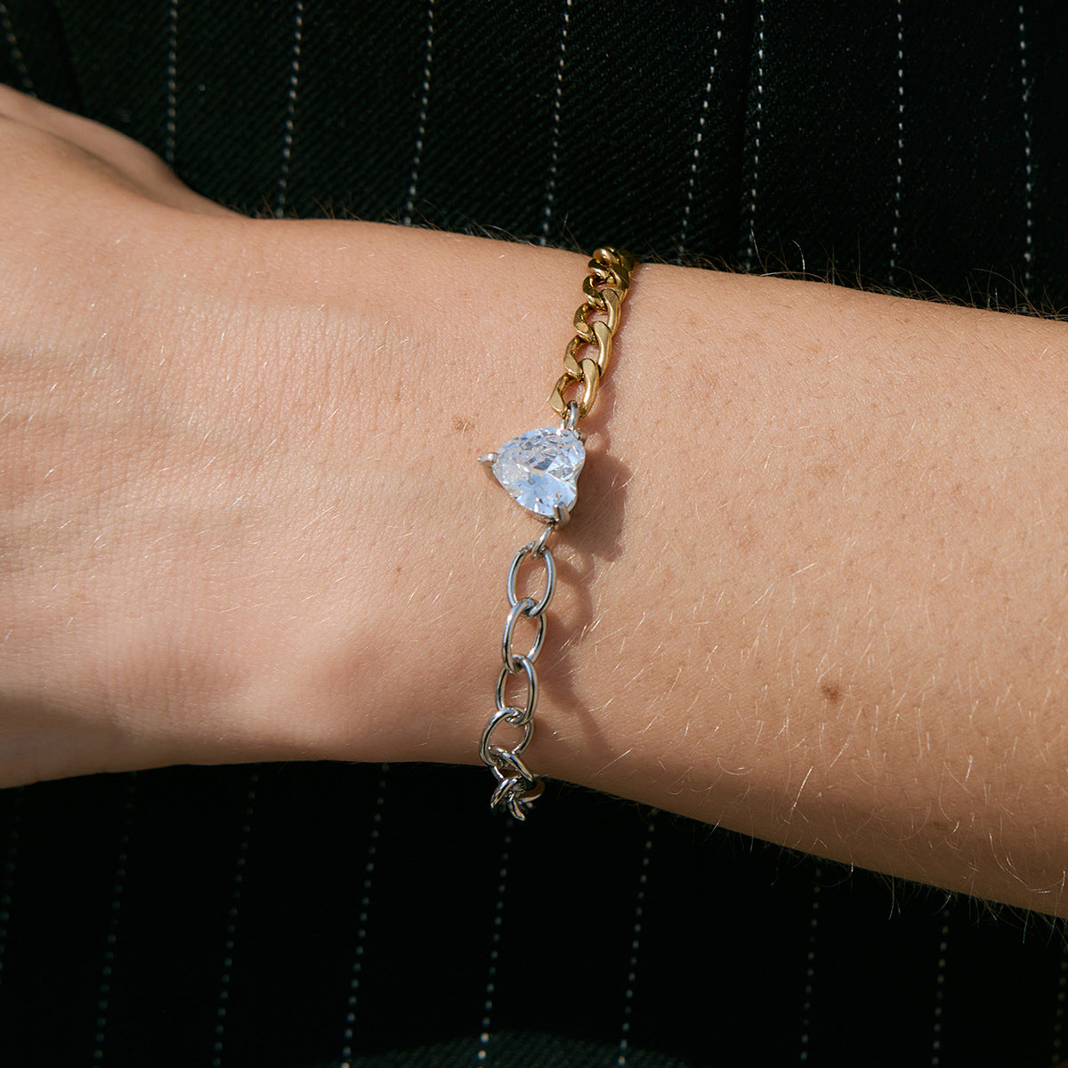 Heart-center chain bracelet worn close-up