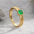 upright view of the green agate ring and scrollwork shoulders