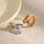 Gold-tone and silver-tone paired-head rings on fabric