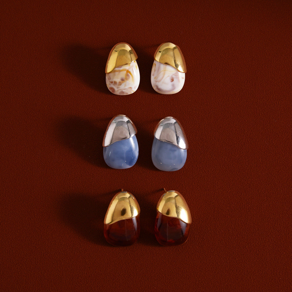 Three marbled resin stud color combinations