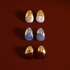 Three marbled resin stud color combinations