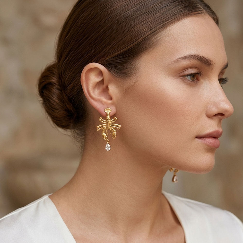 Model wearing lobster earring with clear teardrop