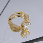 angled view of crossed clear-stone bands and raised center setting