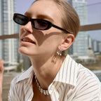 Pear-drop earrings styled with sunglasses