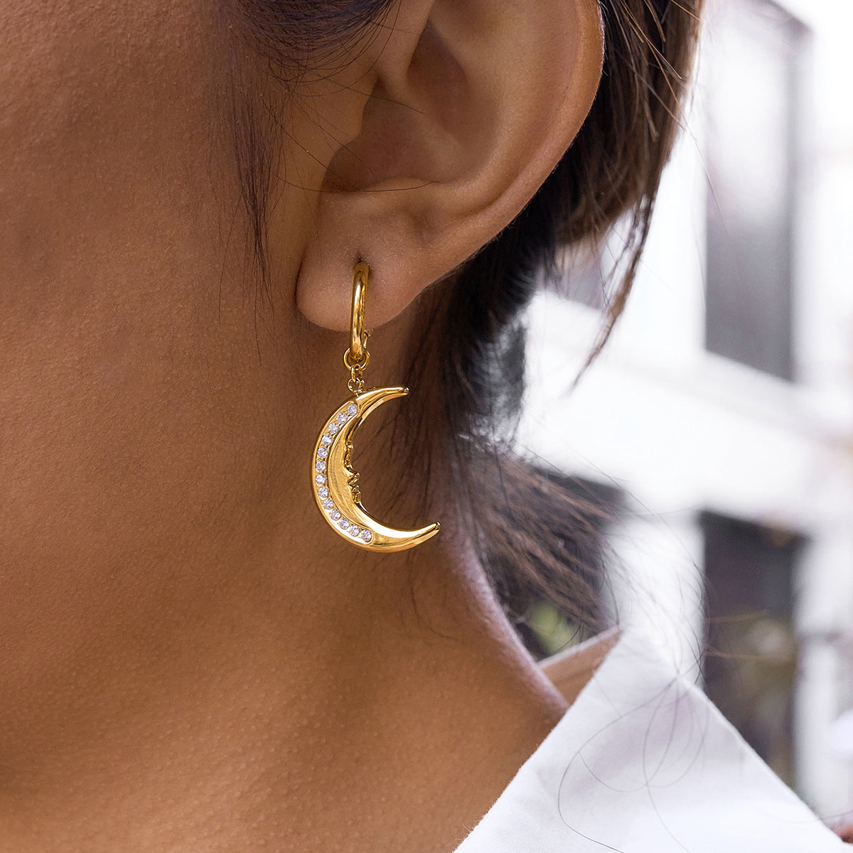 face-profile crescent moon drop earring worn from the side