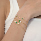 Green stone bracelets layered on a wrist
