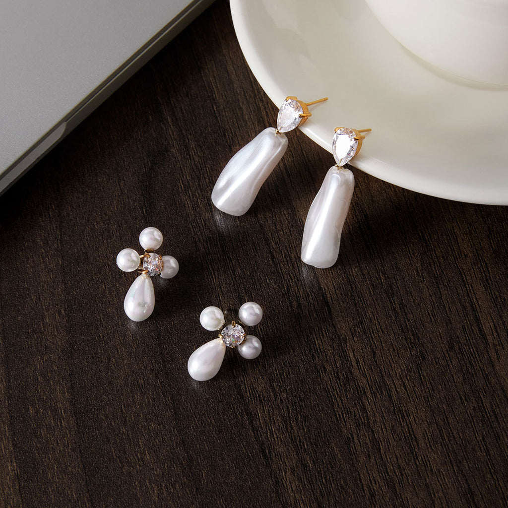 Two white accent earring styles on a plate