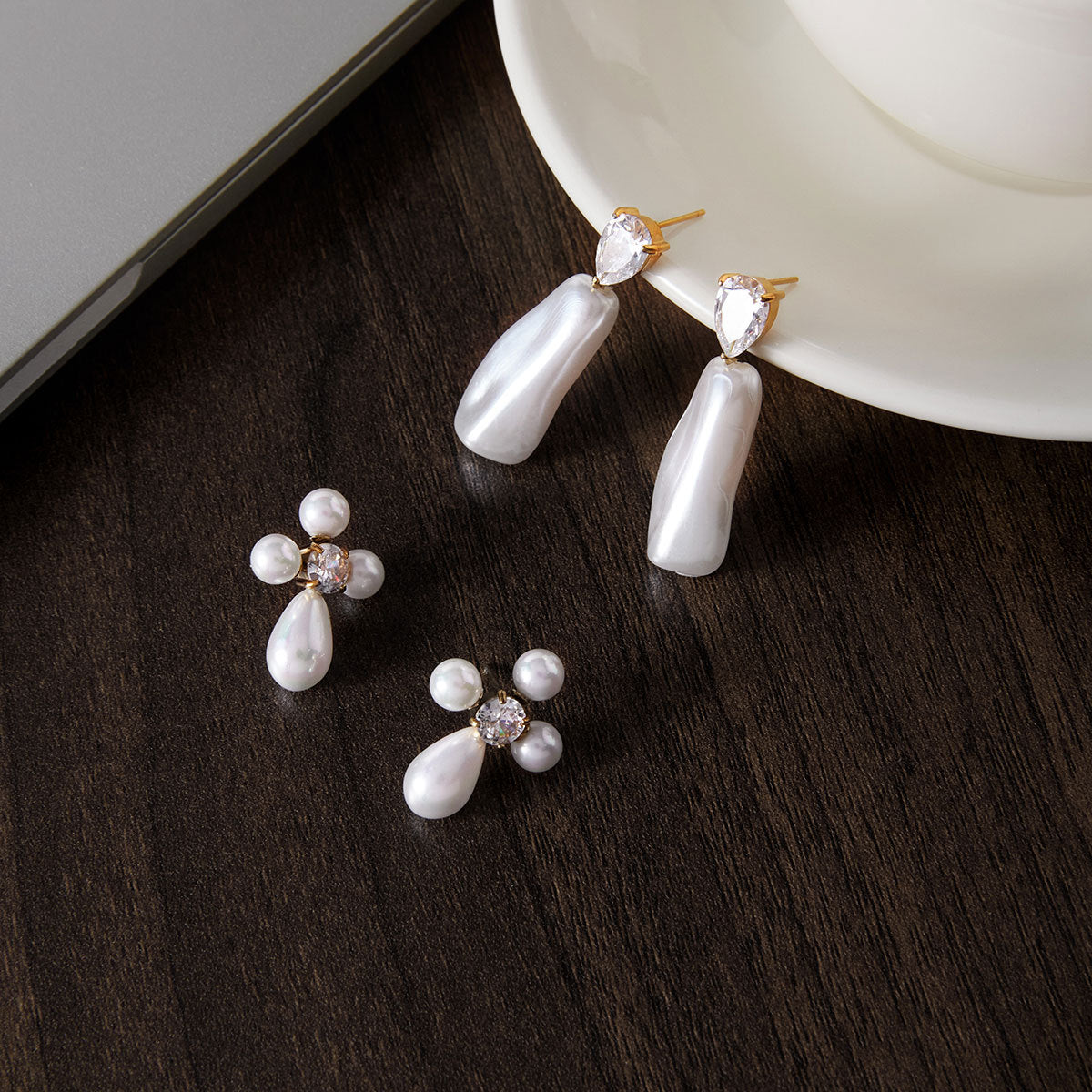 Two white accent earring styles on a plate