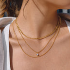 gold plated three-layer clear-stone necklace worn at collarbone