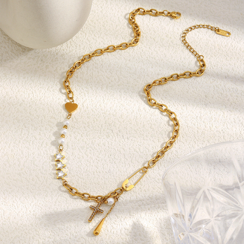 gold plated cross and star charm necklace with white bead stations