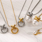 Gold- and silver-finish XO necklaces arranged on pale fabric