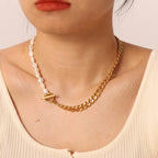 Half-pearl half-chain necklace with front toggle clasp worn at neckline
