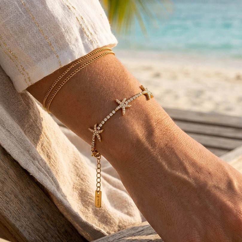 Gold-finish starfish bracelet layered with a plain chain bracelet