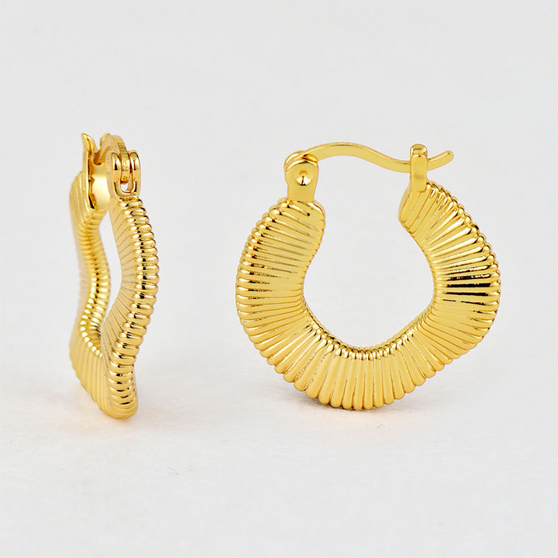 textured brass hoop earrings viewed from front and side