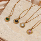four gold plated ribbed square pendants in black green pink and clear