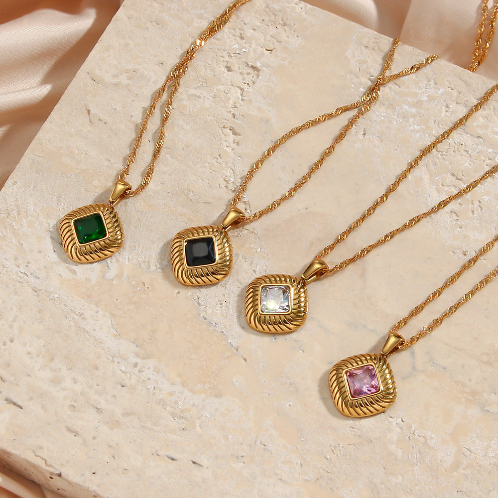 four gold plated ribbed square pendants in black green pink and clear