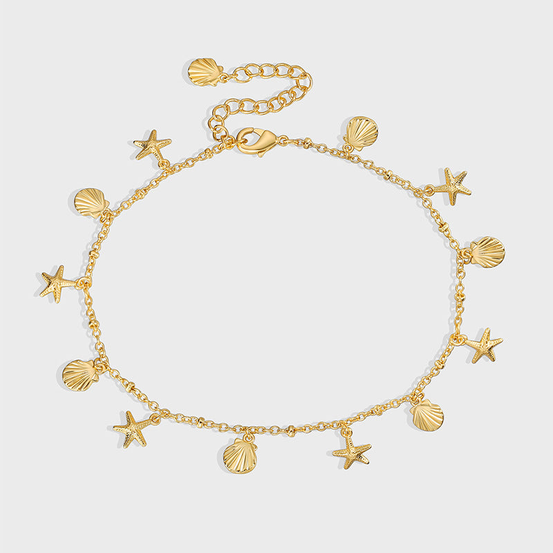 gold plated starfish and scallop charm anklet on gray