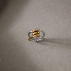 Two-tone interlinked ring on a textured surface