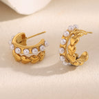 angled pair of gold plated heart and pearl open hoop earrings