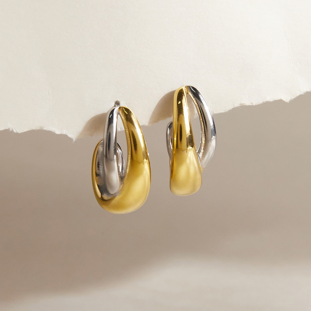 Two-tone sculptural open hoops front view