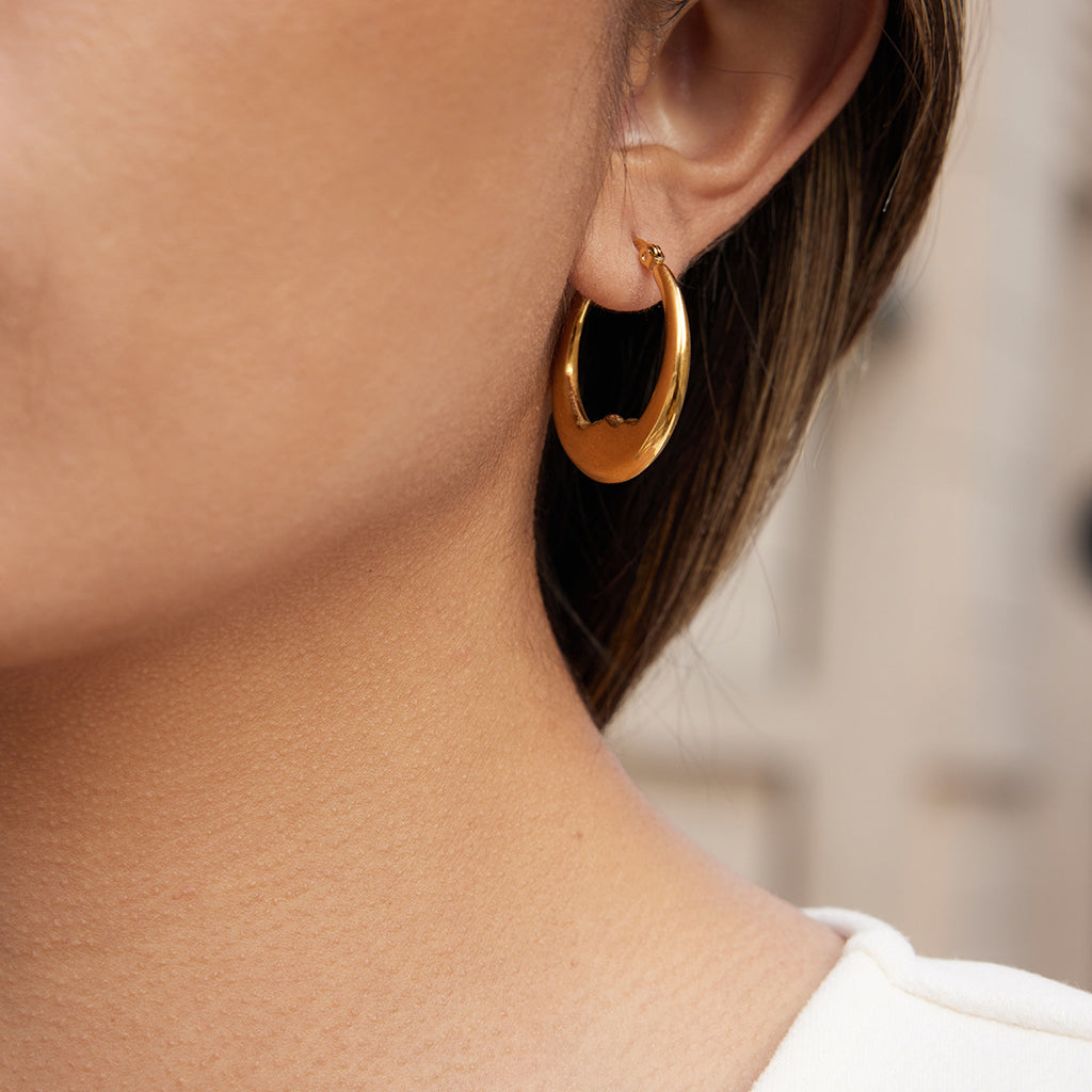 side view of smooth stainless steel wavy hoop earrings