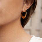 side view of smooth stainless steel wavy hoop earrings