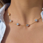 Clear stone station necklace worn with open collar