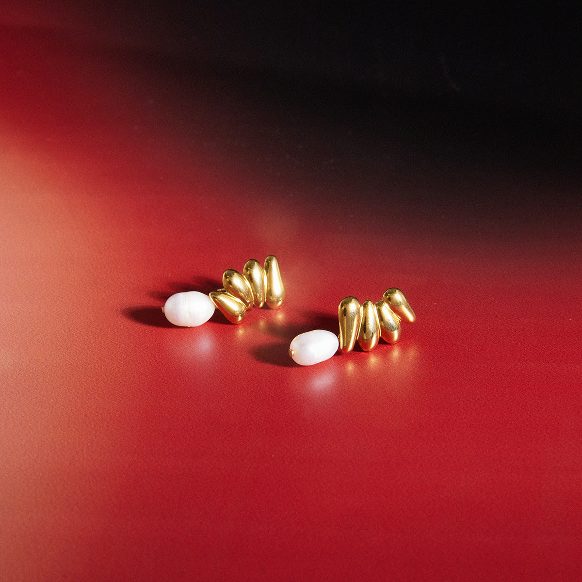 Freshwater pearl cluster earrings on a red surface