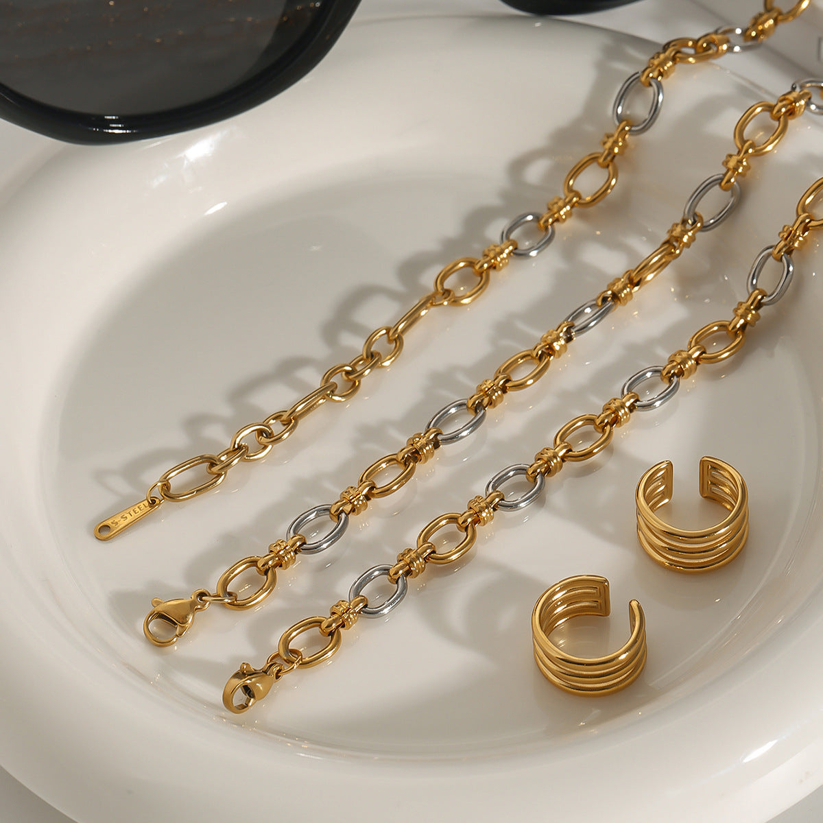 Gold plated paperclip necklace with silver CZ links in a tabletop setting