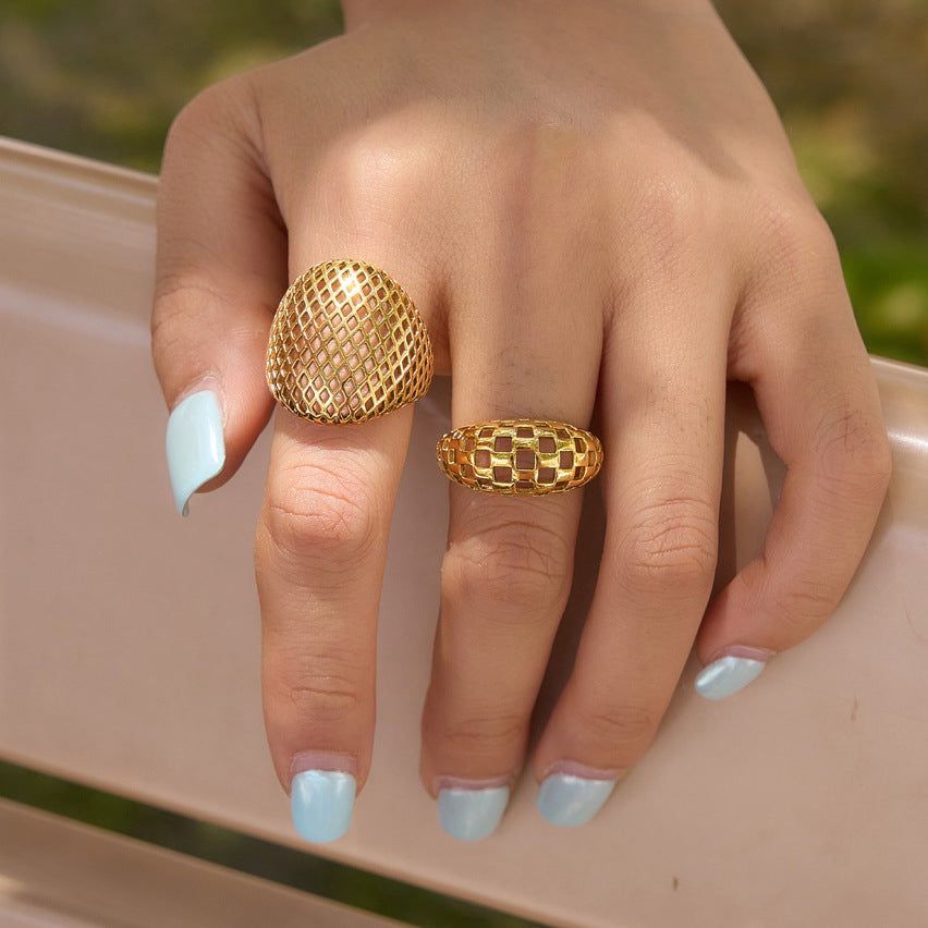 Two gold tone openwork ring shapes shown together